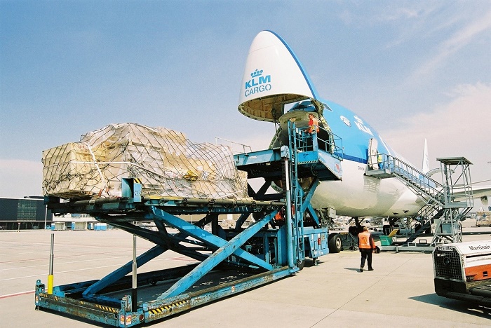 Airplane on platform Schiphol airport being loaded with cargo
