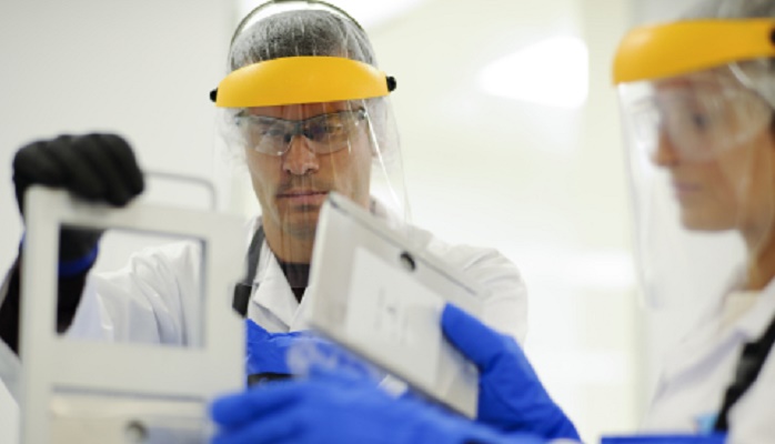 Kite employees at work with device parts