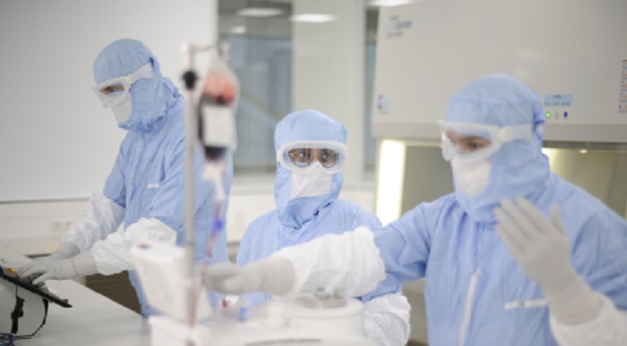 Kite employees in special clothing at work in a laboratory