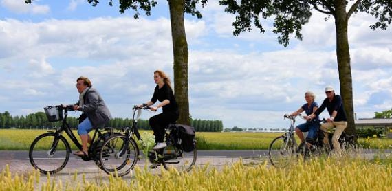 Cyclists on their way in green area PARK21 in Amsterdam Airport City