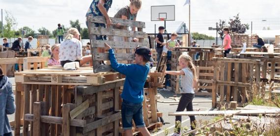 Children playing together and building their own cabin 