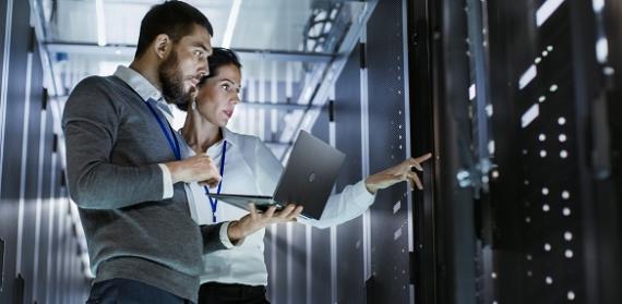 Employees looking at servers in a data center