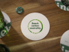 Heineken beer bottle and beermat stating its sustainability goal